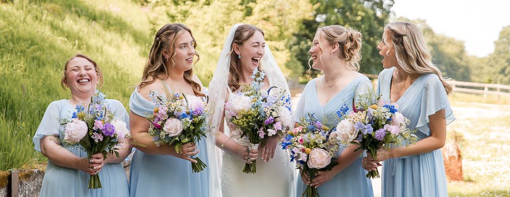 Bridesmaids and bride laughing. Oakbarn Salisbury